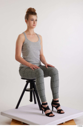 Olivia Sparkle  black high heels sandals casual dressed grey checkered trousers grey tank top sitting whole body  jpg